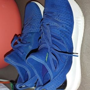 UA Steph Curry sneakers. Blue with neon yellow logo.